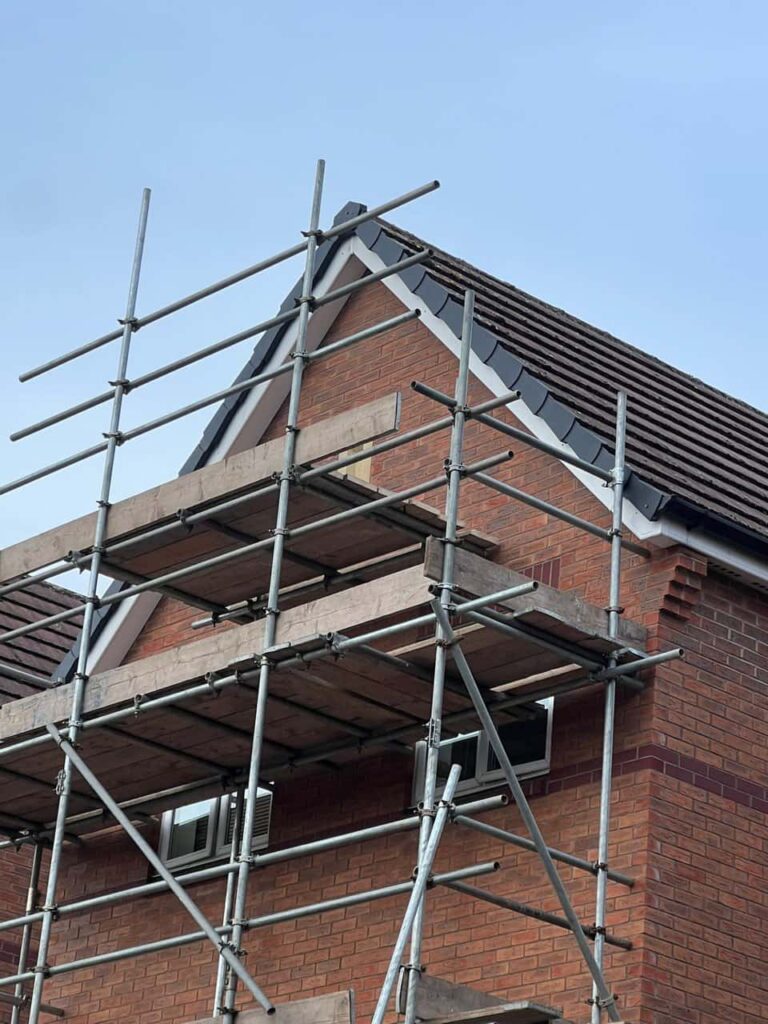 This is a photo of a roof which has just been repaired. There is a scaffold located at the gable end for access onto the roof. Works carried out by Horndean Roofing Repairs