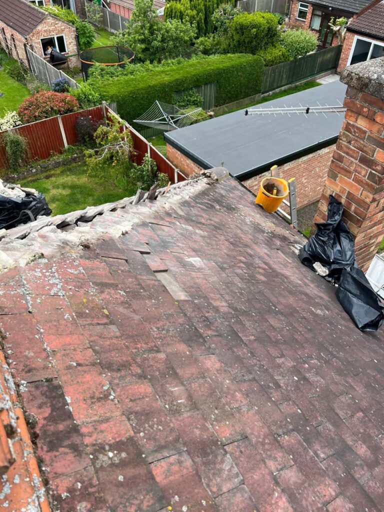 This is a photo taken from a roof showing the hip tiles which have been removed and are just about to be repaired