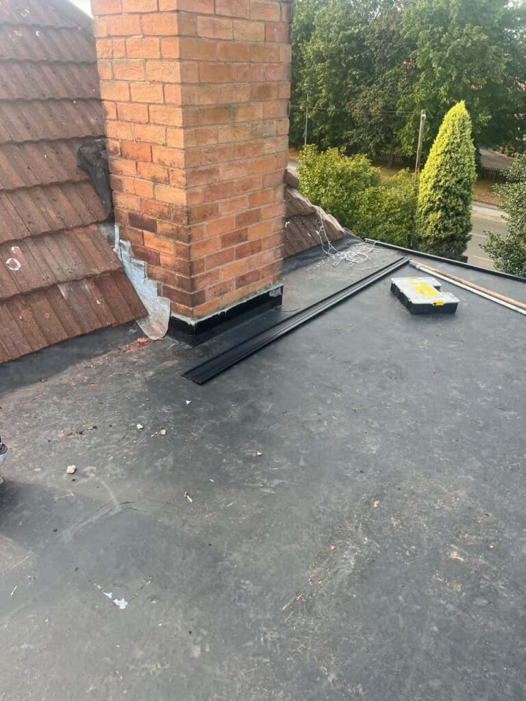 This is a photo of a flat roof which has just been repaired, there is also a chimney stack and some leadwork has also been dressed. Works carried out by Horndean Roofing Repairs